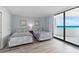 Charming bedroom with two beds, sliding glass door leading to ocean view balcony at 1420 N Atlantic Ave # 202, Daytona Beach, FL 32118