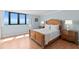 Well-lit bedroom showcasing hardwood floors and an ocean view at 1420 N Atlantic Ave # 202, Daytona Beach, FL 32118