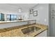 Kitchen counter overlooking a living area, with an ocean view at 1420 N Atlantic Ave # 202, Daytona Beach, FL 32118