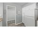 A compact kitchen with a pantry and a full-size refrigerator at 1420 N Atlantic Ave # 202, Daytona Beach, FL 32118
