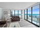 Inviting living room with comfy seating, ocean views, and access to the balcony at 1420 N Atlantic Ave # 202, Daytona Beach, FL 32118