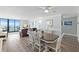 Open-concept living space with dining, living, and ocean views from large sliding doors at 1420 N Atlantic Ave # 202, Daytona Beach, FL 32118