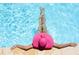 Relaxing in a crystal-clear blue pool with a stylish pink hat, enjoying a serene and sunny day at 1420 N Atlantic Ave # 202, Daytona Beach, FL 32118