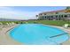 Inviting community pool surrounded by lawn and lounge chairs, perfect for relaxation and socializing at 1420 N Atlantic Ave # 202, Daytona Beach, FL 32118
