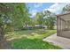 Lush backyard with a wooden fence, providing privacy and plenty of green space at 1562 Monroe St, Deland, FL 32720