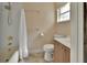 Bathroom with a shower and tub combo, toilet, sink with vanity, and a window at 1562 Monroe St, Deland, FL 32720