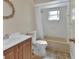 Bathroom with a shower and tub combo, toilet, and a sink with vanity at 1562 Monroe St, Deland, FL 32720