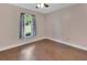 Bedroom with wood floors and a window offering natural light and view at 1562 Monroe St, Deland, FL 32720