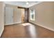 Bedroom with wood floors, barn door to bathroom, and a window for natural light at 1562 Monroe St, Deland, FL 32720