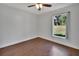 Bright bedroom with wood floors and a window overlooking the backyard at 1562 Monroe St, Deland, FL 32720