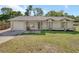 Charming single-story home with a well-maintained lawn, attached garage, and neutral-toned exterior at 1562 Monroe St, Deland, FL 32720