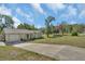 Inviting front exterior with a long driveway and manicured lawn at 1562 Monroe St, Deland, FL 32720