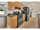 Modern kitchen featuring wooden cabinets, black appliances, and tile flooring at 1562 Monroe St, Deland, FL 32720