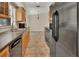 Kitchen with wood cabinets, black appliances, and tile floor, open to dining area at 1562 Monroe St, Deland, FL 32720