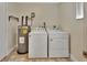 Bright laundry area with washer, dryer, and water heater; convenient for household chores at 1562 Monroe St, Deland, FL 32720