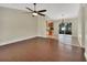 Open-concept living space with wood flooring, ceiling fan, and sliding glass doors leading to the outdoors at 1562 Monroe St, Deland, FL 32720