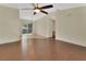 Spacious living room featuring wood floors, ceiling fan, and sliding glass doors to the lanai at 1562 Monroe St, Deland, FL 32720