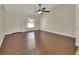 Bright, spacious living room featuring wood floors, a ceiling fan, and ample natural light from a large window at 1562 Monroe St, Deland, FL 32720