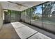 View of the screened lanai with a ceiling fan, offering a relaxing outdoor space at 1562 Monroe St, Deland, FL 32720