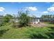 Spacious backyard featuring a small patio and lush green lawn, perfect for outdoor activities at 1608 Raleigh Ave, Daytona Beach, FL 32117