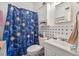 Bathroom featuring celestial shower curtain and cabinet over toilet at 1608 Raleigh Ave, Daytona Beach, FL 32117