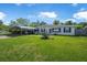 Charming home featuring a well-manicured front lawn, carport, and vibrant curb appeal at 1608 Raleigh Ave, Daytona Beach, FL 32117