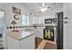 Functional kitchen features white cabinetry, black appliances, and a window for natural light at 1608 Raleigh Ave, Daytona Beach, FL 32117