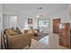 Cozy living room with tile flooring, ceiling fan, and comfortable furniture arrangement at 1608 Raleigh Ave, Daytona Beach, FL 32117