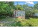 Outdoor storage shed surrounded by lush greenery, providing ample space for tools and equipment at 1608 Raleigh Ave, Daytona Beach, FL 32117