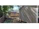 A backyard view showcases a storage shed and adjacent tan home, partially shaded by mature trees at 1621 Anniston Ave, Daytona Beach, FL 32117