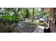 Backyard view with mature trees, lush greenery, and a glimpse of the neighboring properties at 1621 Anniston Ave, Daytona Beach, FL 32117