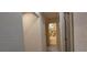 Hallway view into bathroom featuring cream and brown tiled walls and a white tub and shower at 1621 Anniston Ave, Daytona Beach, FL 32117