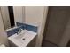 Nicely appointed bathroom featuring blue accent tiles, a modern sink and vanity, and updated fixtures at 1621 Anniston Ave, Daytona Beach, FL 32117