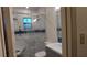 Beautiful bathroom featuring marble-tiled shower, blue accent tiles, and a stylish vanity at 1621 Anniston Ave, Daytona Beach, FL 32117
