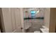 Well-lit bathroom featuring a tiled shower with glass door, comfortable seat, and modern sink with vanity at 1621 Anniston Ave, Daytona Beach, FL 32117
