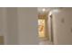 Hallway view into bathroom featuring cream and brown tiled walls and a white tub and shower at 1621 Anniston Ave, Daytona Beach, FL 32117