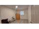 Clean bedroom featuring light gray flooring, a wooden dresser, and a minimalist aesthetic at 1621 Anniston Ave, Daytona Beach, FL 32117