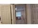 View of bedroom through open doors, featuring light gray flooring, blinds and natural light at 1621 Anniston Ave, Daytona Beach, FL 32117