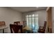 Bright dining room with a glass top table and carved wood chairs, illuminated by natural light at 1621 Anniston Ave, Daytona Beach, FL 32117