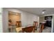 Open dining area with glass table and wood chairs, seamlessly connecting to the living room and kitchen at 1621 Anniston Ave, Daytona Beach, FL 32117