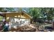 Side angle view of the home's exterior showing the two car garage and driveway at 1621 Anniston Ave, Daytona Beach, FL 32117