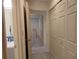 Hallway view featuring closet space, light gray wood floors, and neutral paint tones at 1621 Anniston Ave, Daytona Beach, FL 32117