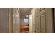 Hallway featuring wood-look floors, leading to a bedroom with ample closet space at 1621 Anniston Ave, Daytona Beach, FL 32117