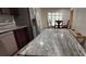 Spacious kitchen features granite countertops, stainless steel appliances, and adjacent dining area for convenient meals at 1621 Anniston Ave, Daytona Beach, FL 32117