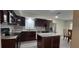 Modern kitchen featuring stainless steel appliances, dark cabinets, granite countertops, and a center island at 1621 Anniston Ave, Daytona Beach, FL 32117