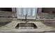 Modern stainless steel kitchen sink with stylish faucet and marble countertops, complemented by white shutters at 1621 Anniston Ave, Daytona Beach, FL 32117