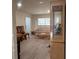 Open living room with wood-look flooring, a large window, and a comfortable seating area at 1621 Anniston Ave, Daytona Beach, FL 32117
