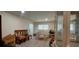 Bright living room with wood floors, neutral paint, and comfortable seating arrangement by the window at 1621 Anniston Ave, Daytona Beach, FL 32117