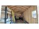 Inside the shed is a spacious interior with shelving, a ladder, and ample room for storage at 1621 Anniston Ave, Daytona Beach, FL 32117