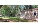 Exterior view of the shed in the backyard with lush greenery and a wood fence at 1621 Anniston Ave, Daytona Beach, FL 32117